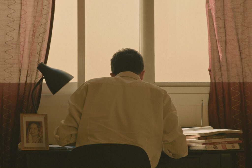 A young chef seated at a desk, studying late into the night, in a scene from Chronicles of a Chef Episode 1: ROOTS.